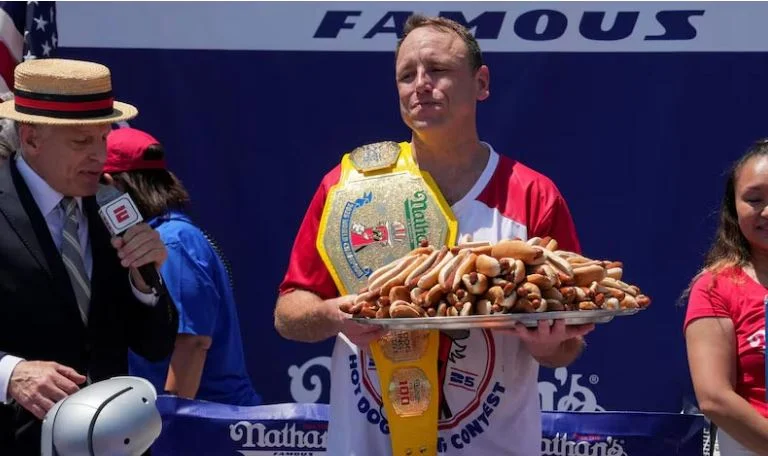Longtime champion Joey Chestnut downs 71 hot dogs to reclaim title
